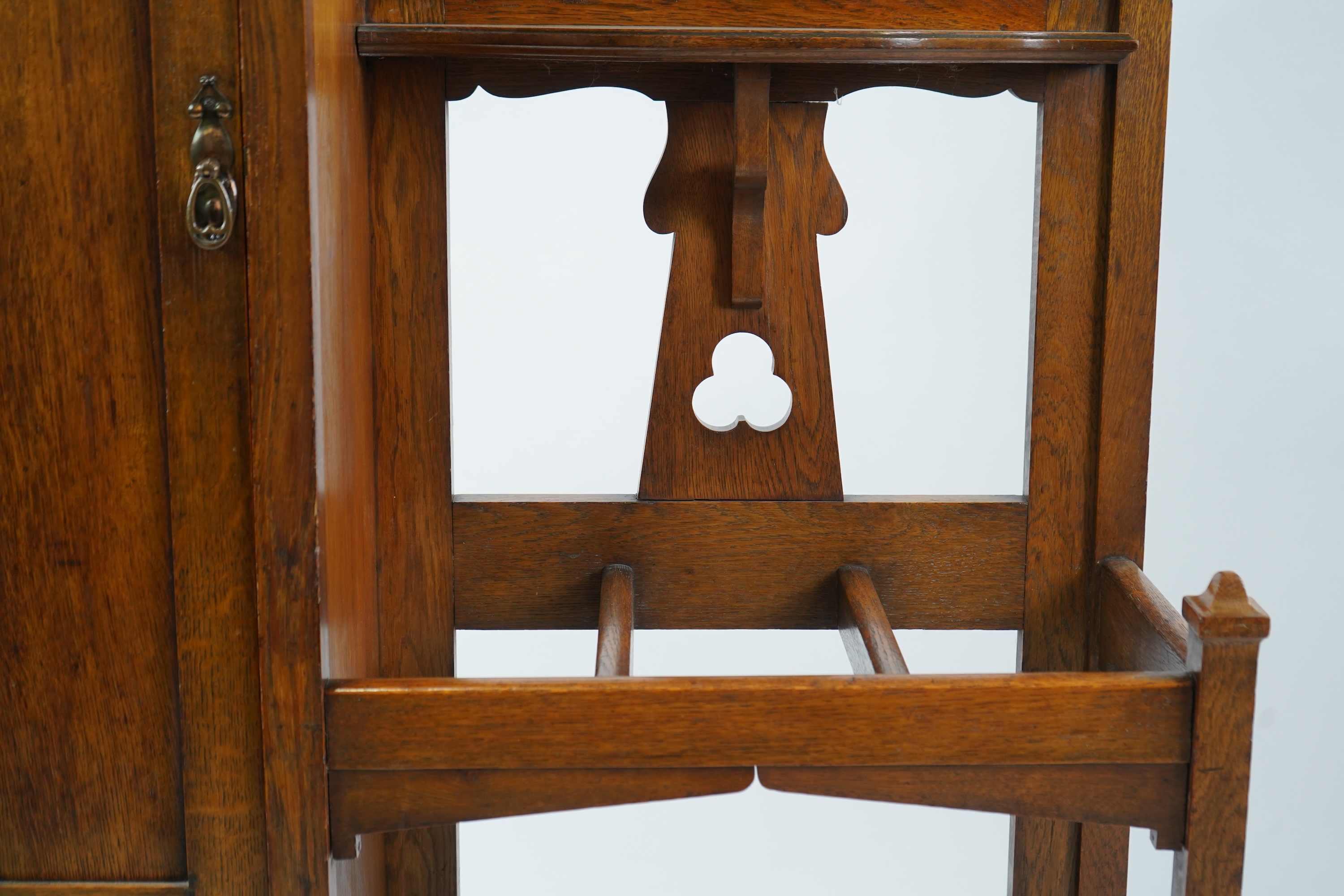 Manner of Liberty & Co: An Arts and Crafts embossed copper mounted oak hall cupboard